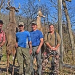 hunters with deer at meat pole