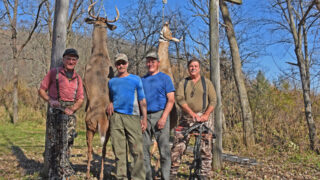 hunters with deer at meat pole