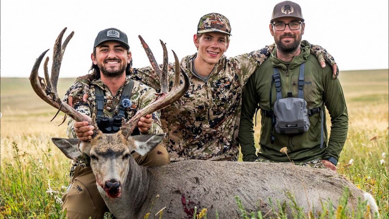 Bowhunter Chris Bee and friends with a big mule deer.