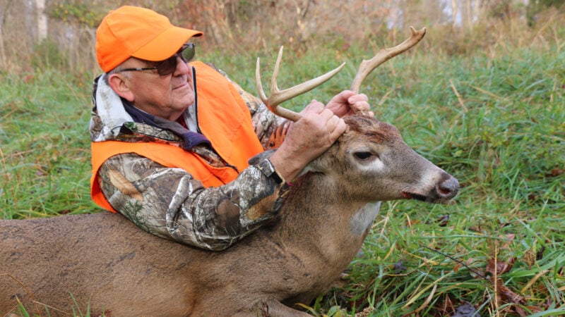 hunter holding buck