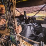 bowhunter in blind with bow